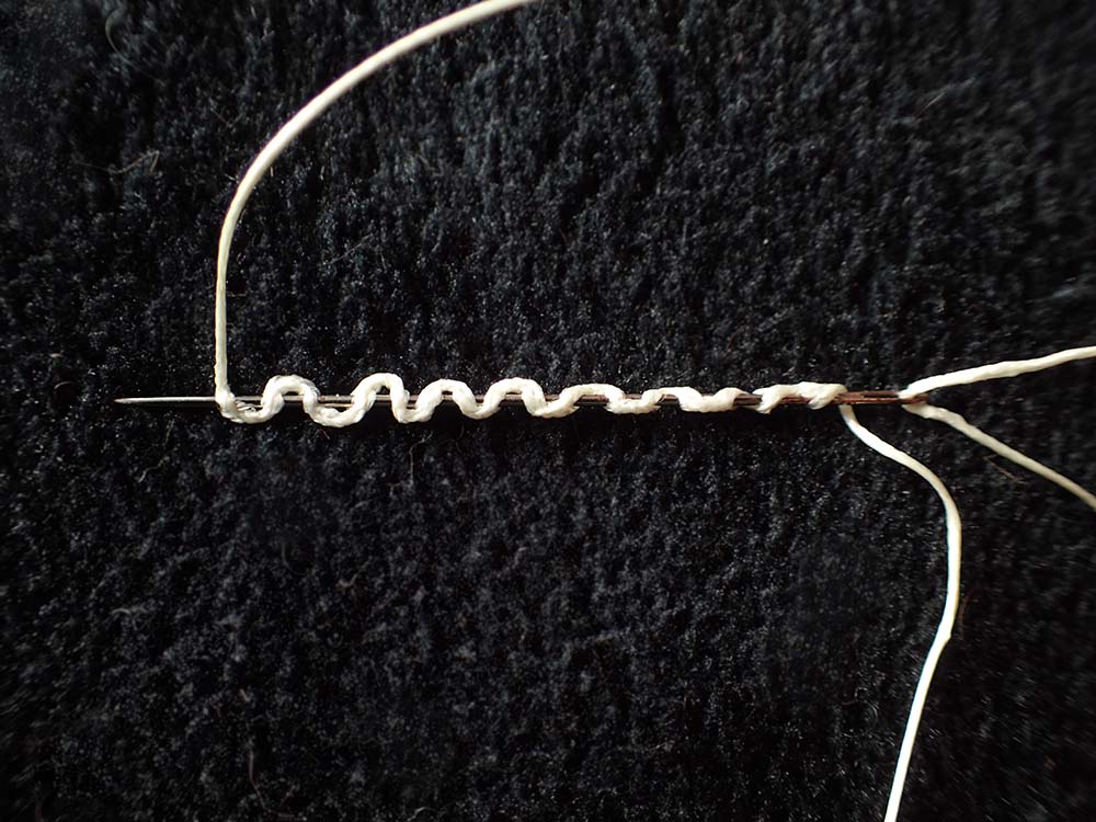 The beginning of a Stitch Splice - first 13 stitches on a needle with black background