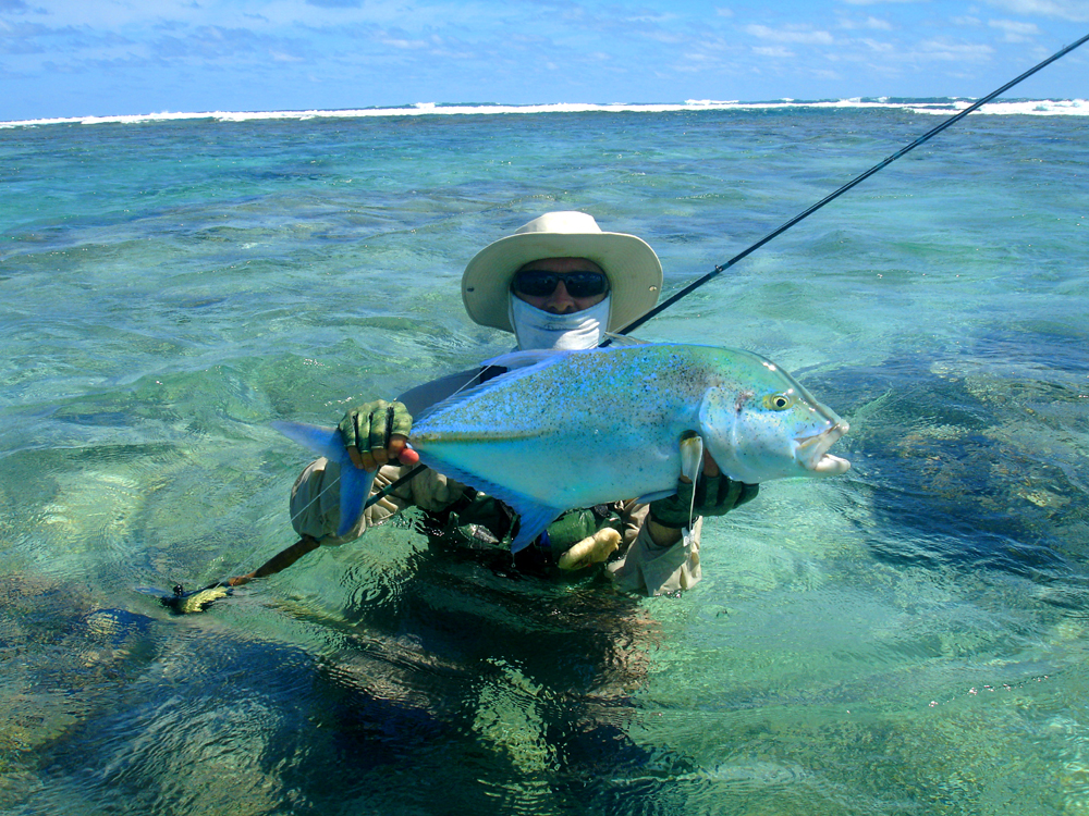 Fly fisherman with trevally Otaki lagoon