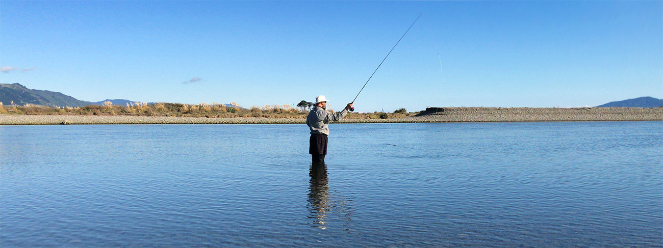 Fly fisherman Sprey casting on North Island river mouth