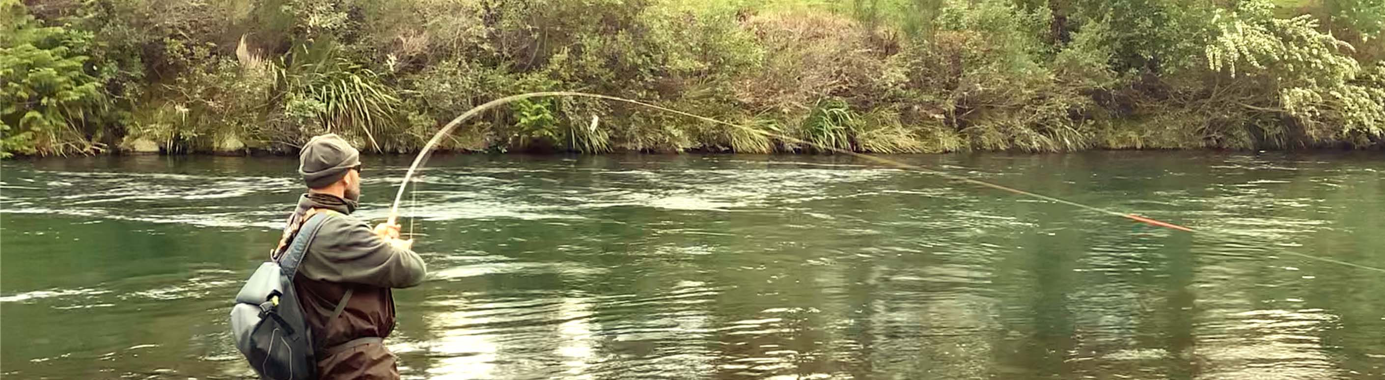 Man-fishing-hooking-a-trout-with-orvis-mission-12-foot-5wt-rod-on-Tongariro-River-New-Zealand