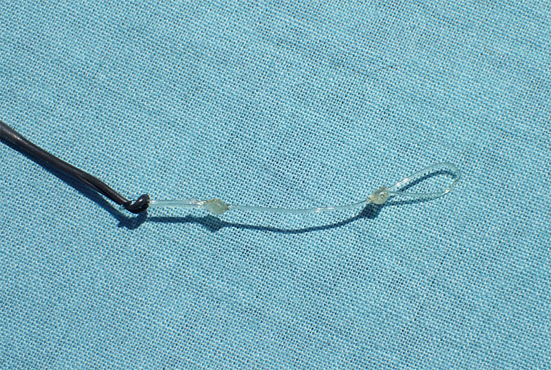 Tippet connector on a blue cloth background